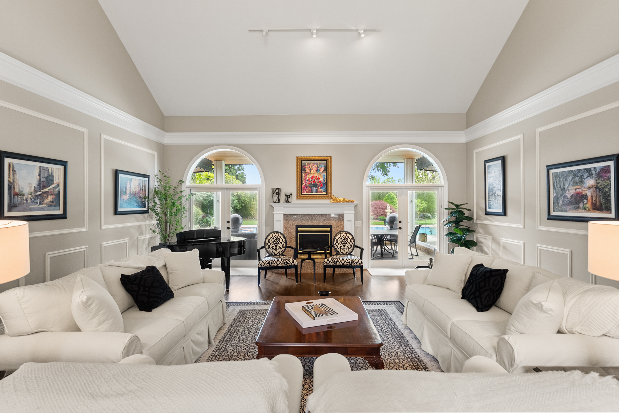 Formal living room with fireplace and arched garden doors